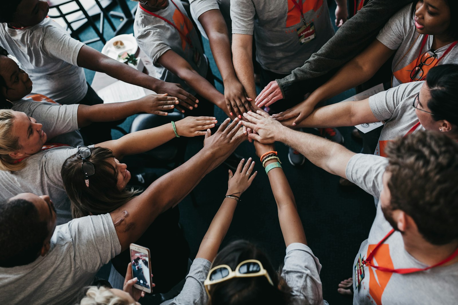 A team stacking hands in the middle of a huddle